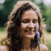 Headshot of a cheerful looking person outdoors.